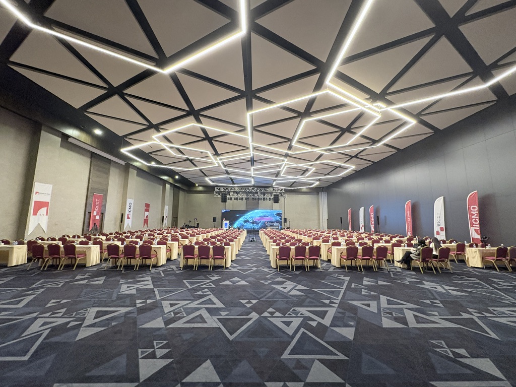 Wide view of the IDCET conference room, stage and geometric ceiling in Antalya.