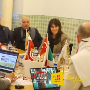 Delegates and national flags around the Build in Africa meeting table.